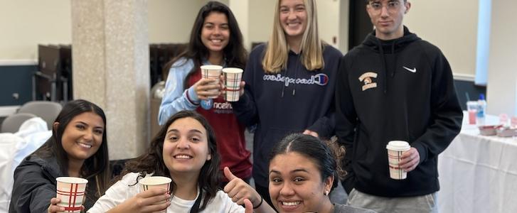 Students holding coffee cups
